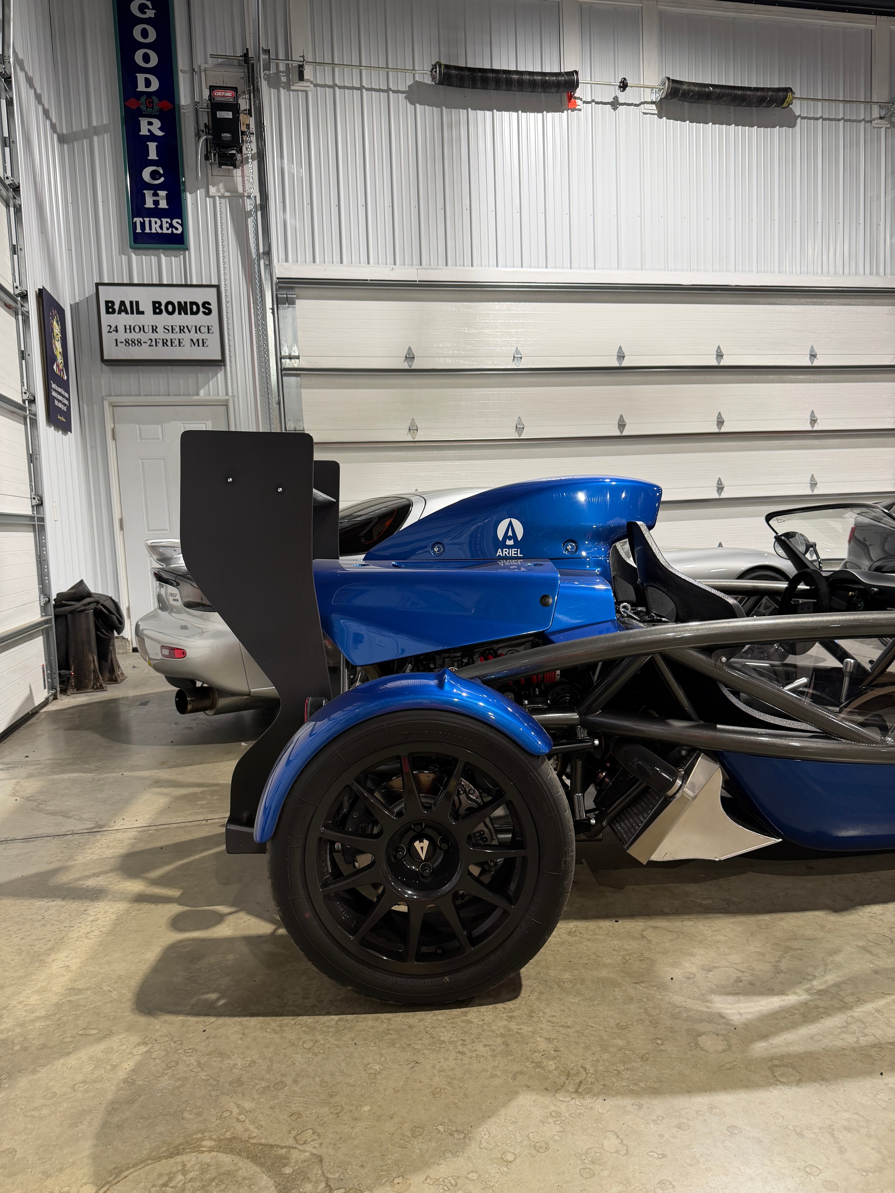 2025 Ariel Atom 4 — close-up of Ariel badge and red coilover suspension