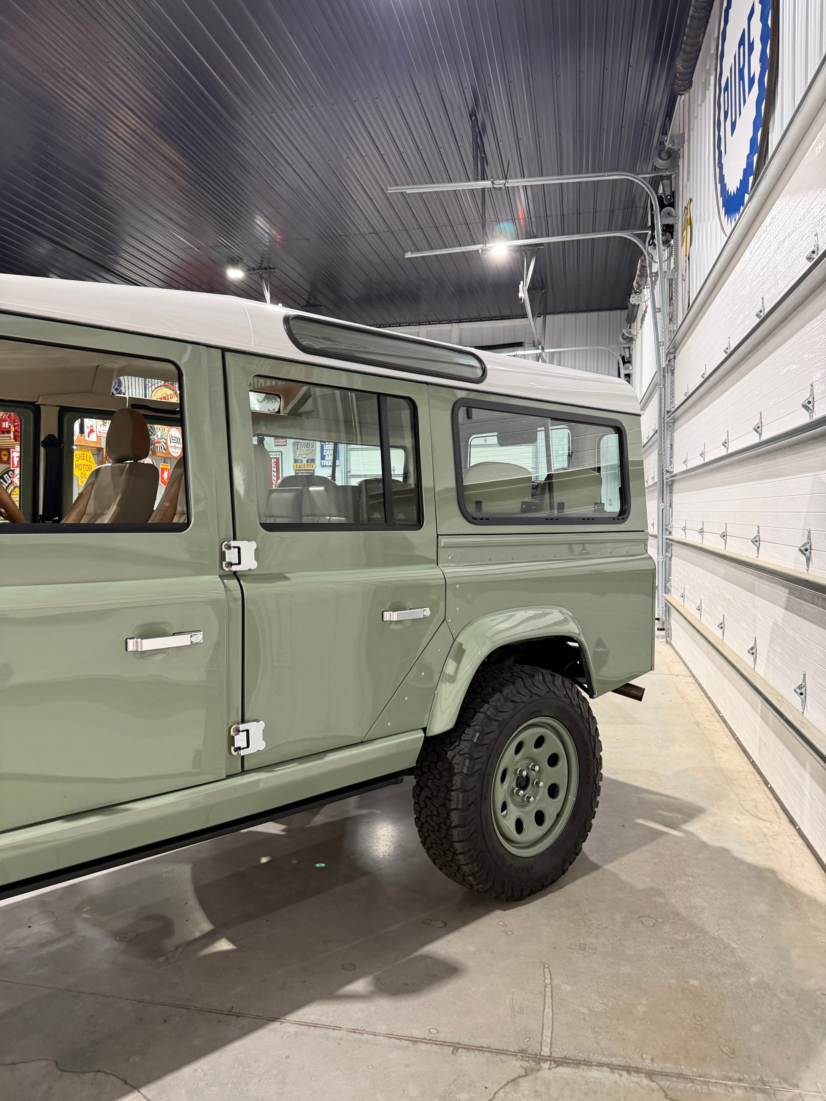1987 Land Rover Defender 110 — leather-wrapped center console and infotainment