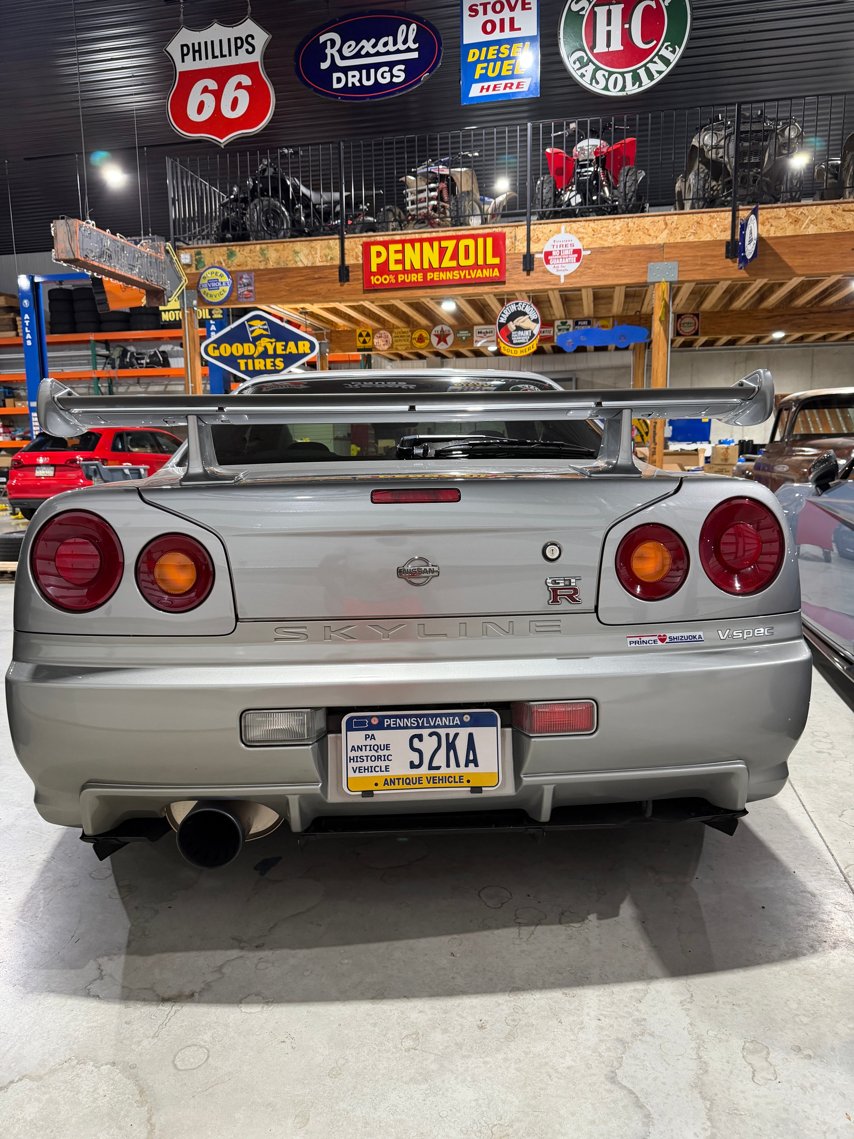 1999 Nissan Skyline GT-R V-Spec R34 — rear three-quarter in shop