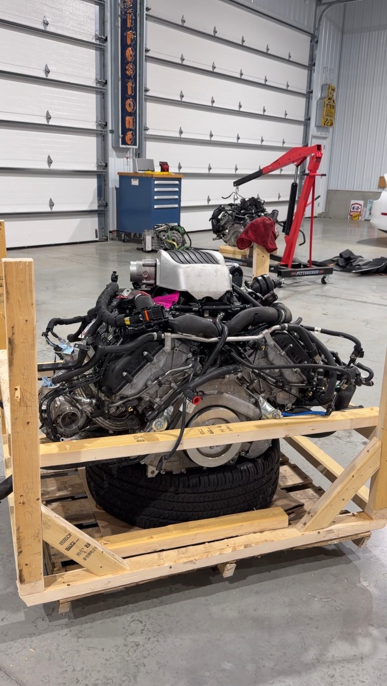 2018 McLaren 570GT — wide shop shot on lift with tech working