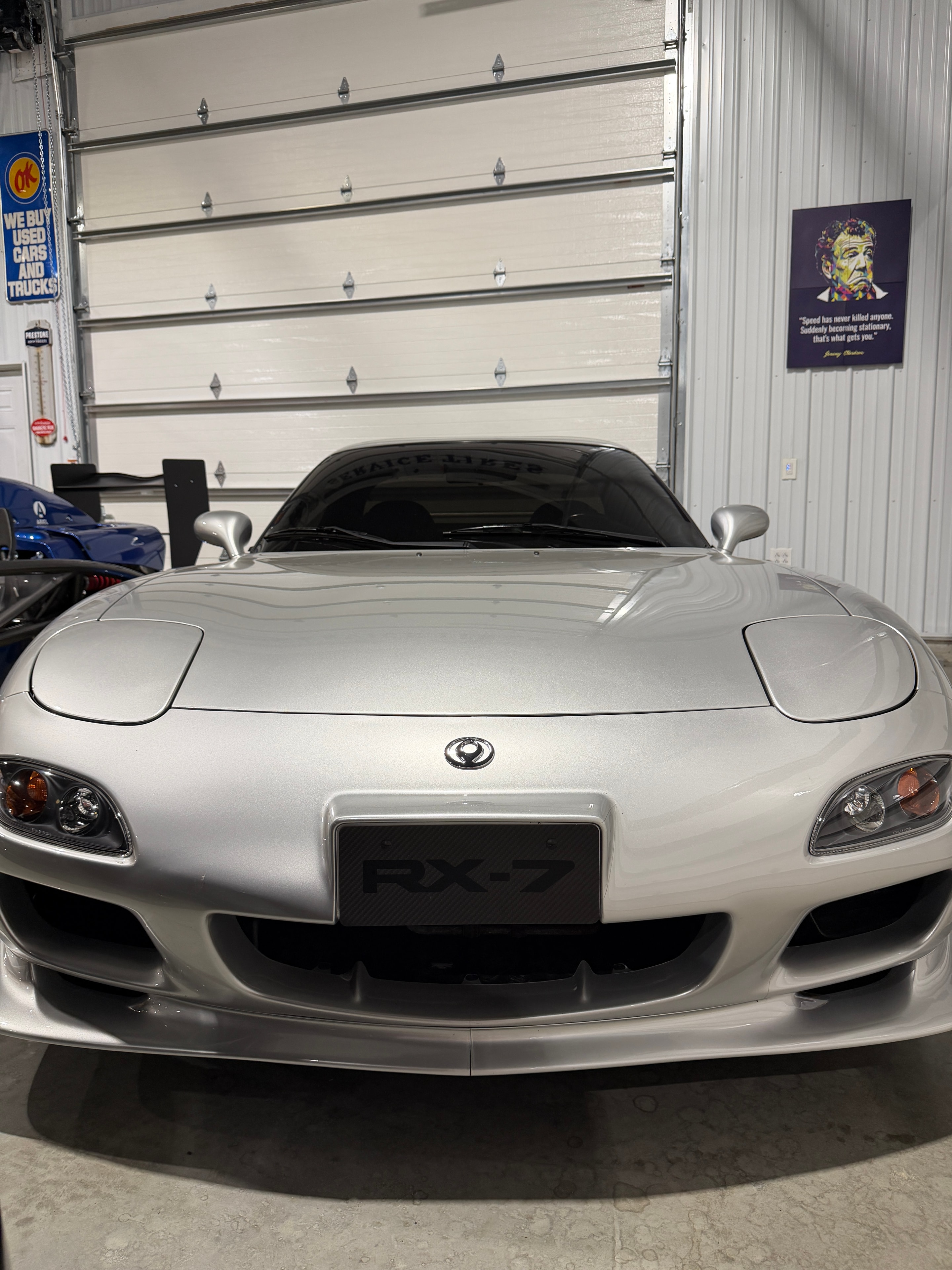 1993 Mazda RX-7 FD3S silver — straight-on front view showing RX-7 badge