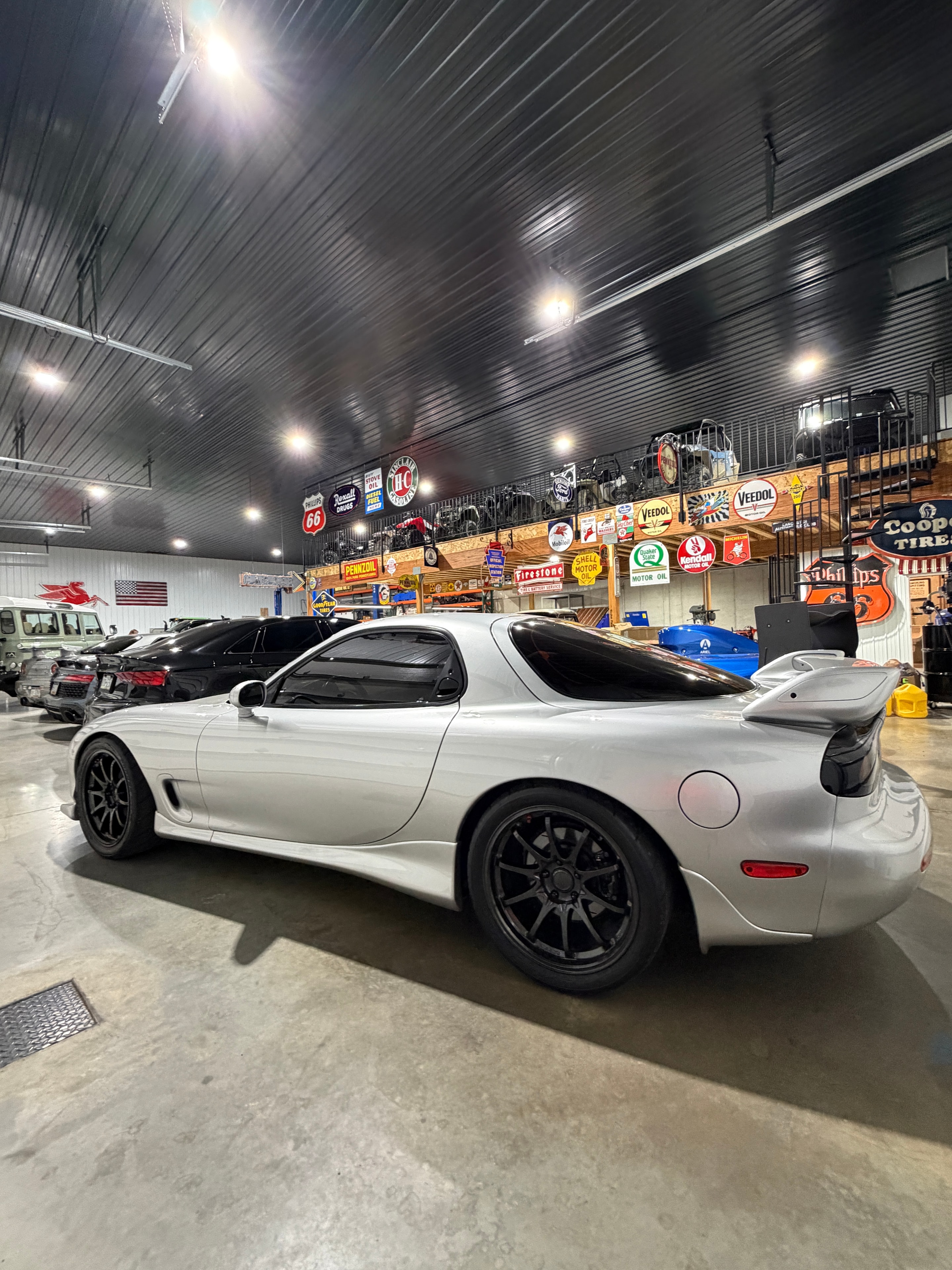 1993 Mazda RX-7 FD3S — side profile at night with vintage oil signs